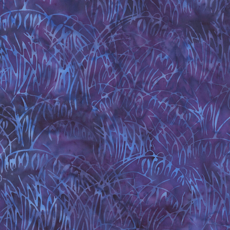 mottled violet batik fabric featuring an abstract grass design in shades of blue and lavender
