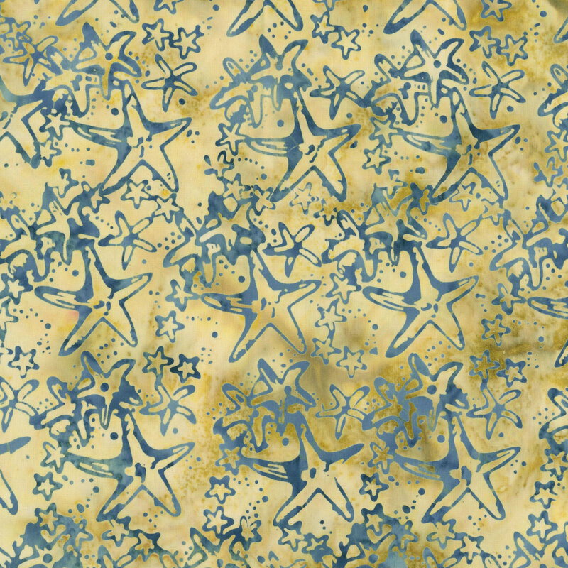 A mottled yellow fabric scattered with starfish of many sizes.