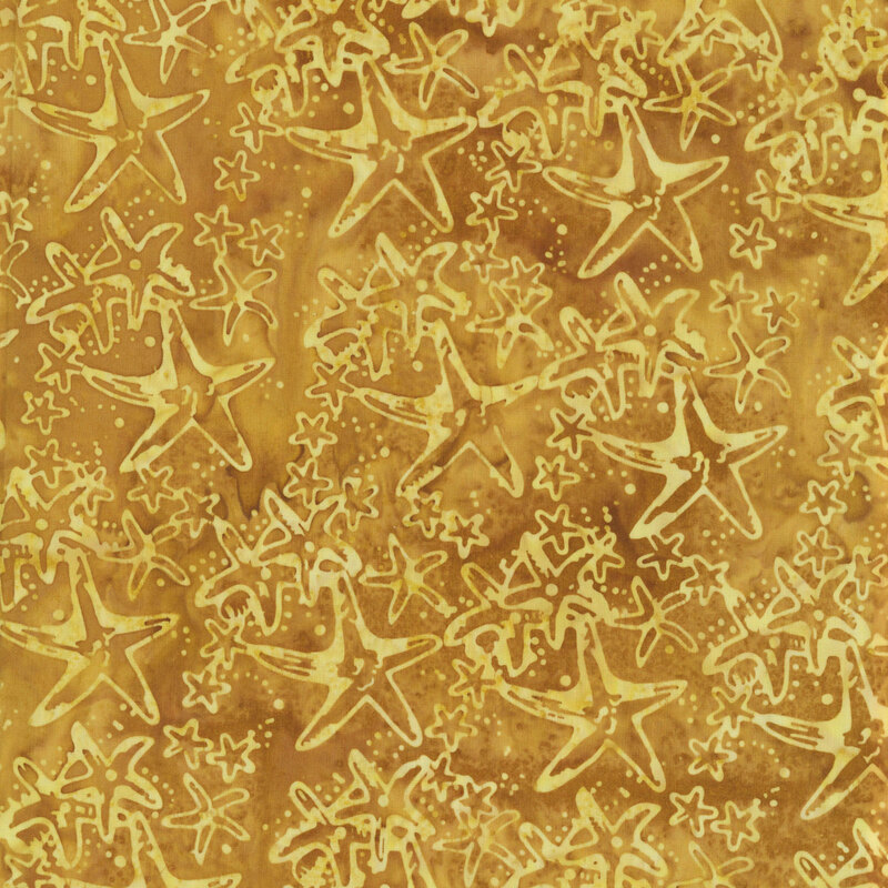 A mottled gold batik with starfish in varying sizes. 