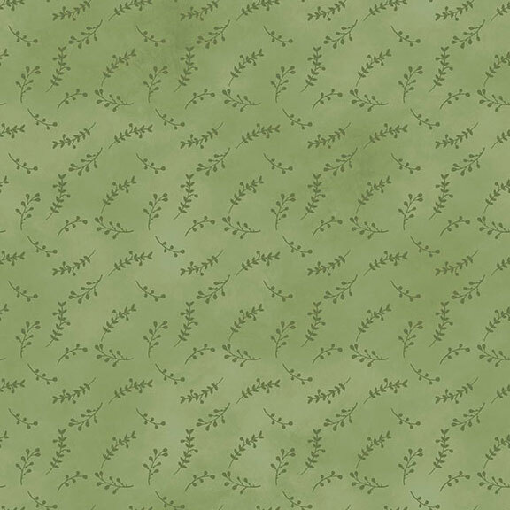 mottled green fabric featuring a tonal print of tossed leaf sprigs