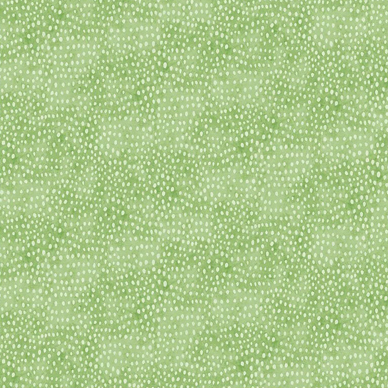 Mottled green fabric with white dotted accents to emulate a seed-like texture