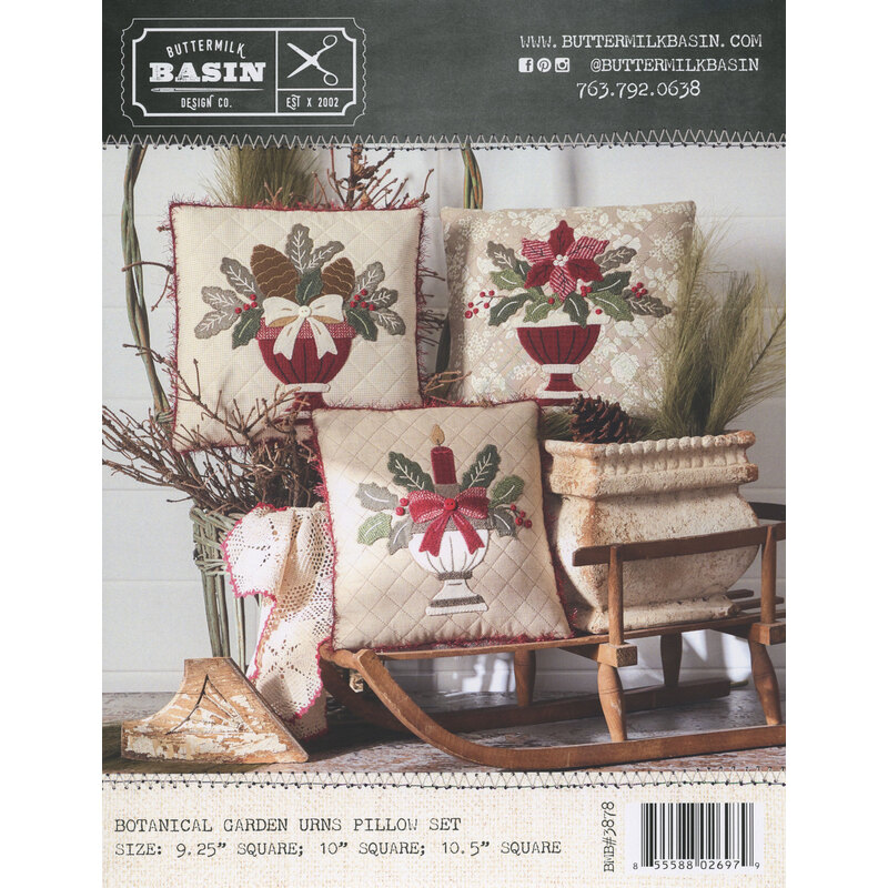Rustic holiday pillow pattern with floral designs arranged on a wooden sled and bench.