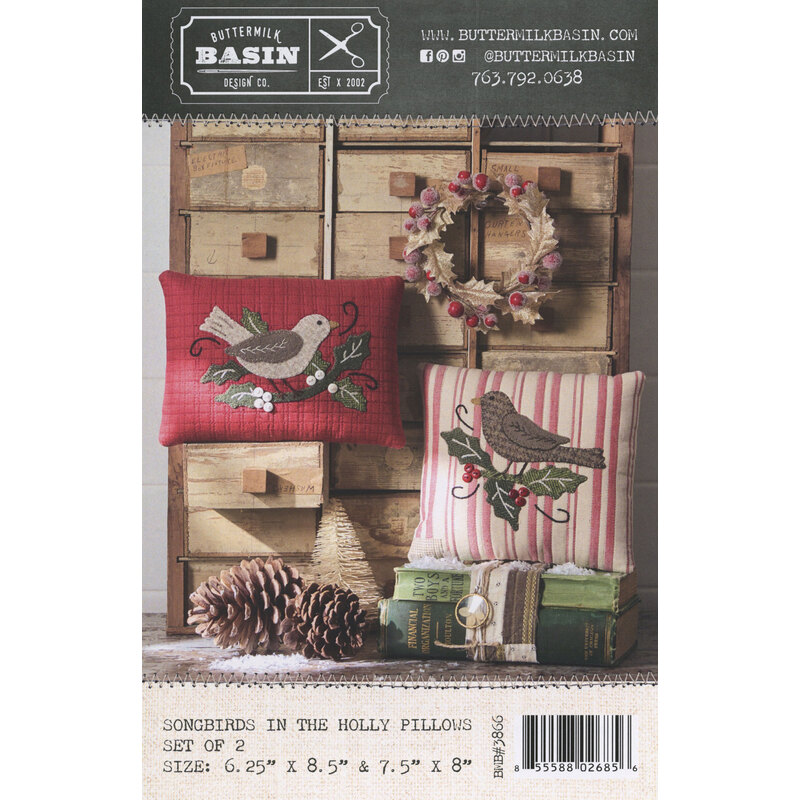Bird-themed pillow pattern with a wreath and pinecones on rustic wooden crates.