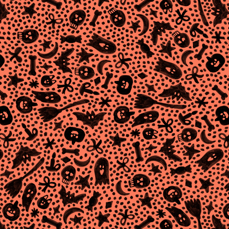 A salmon orange fabric with halloween motifs and scattered dots. 
