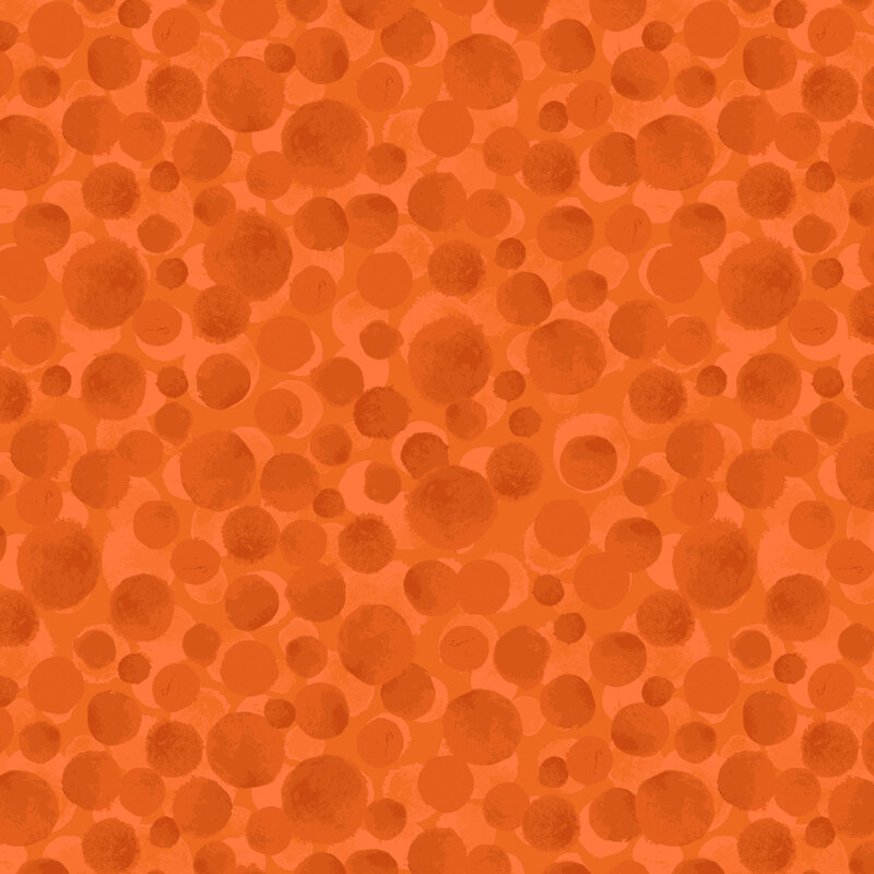 A bright orange fabric with scattered dots.