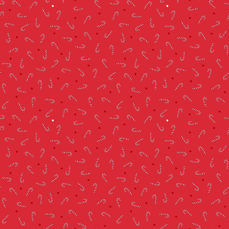 A Christmas red fabric with tossed candy canes and hearts.