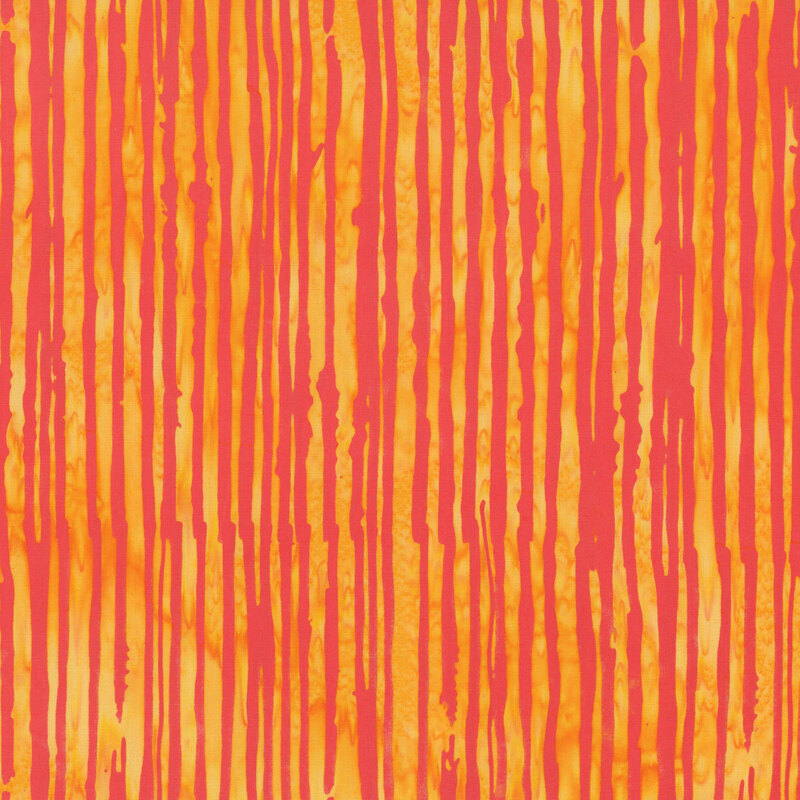A yellow orange batik fabric featuring irregular rouge red vertical stripes.