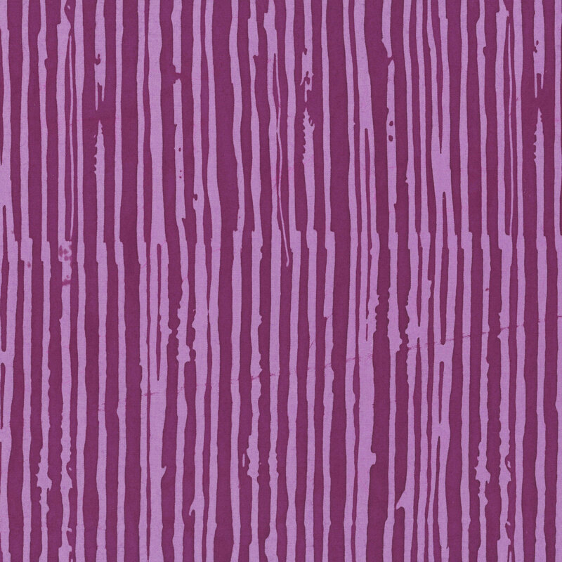 A mauve batik fabric featuring irregular dark magenta vertical stripes.