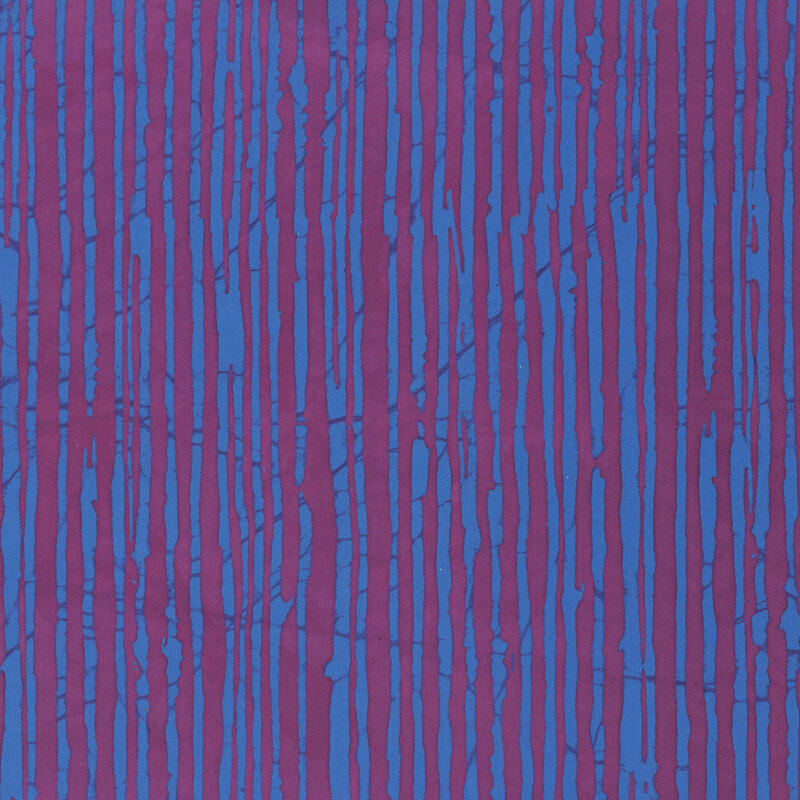 An ultramarine batik fabric featuring irregular dark magenta vertical stripes.