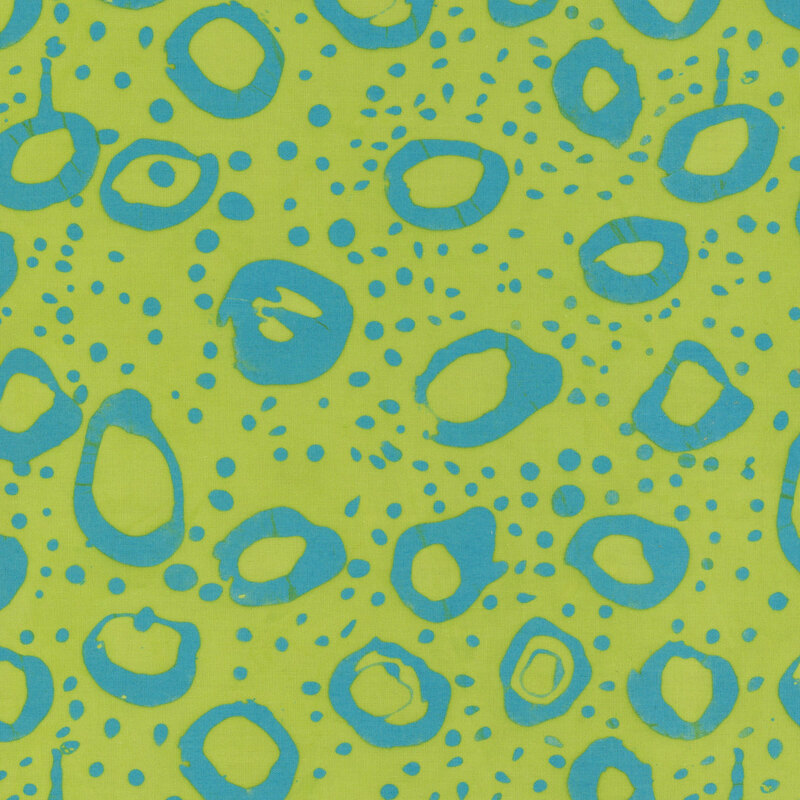 Lime green fabric with irregular stamped circles and dots in teal blue.