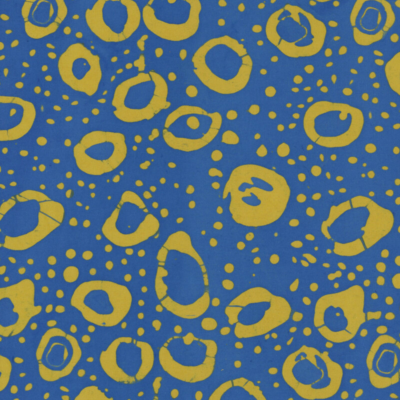 Dark blue fabric with irregular stamped circles and dots in mustard yellow.