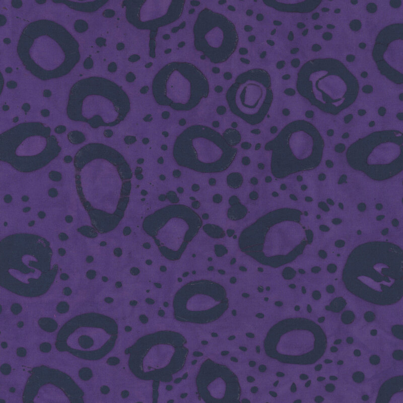 Eggplant purple fabric with irregular stamped circles and dots in dark tonal purple.
