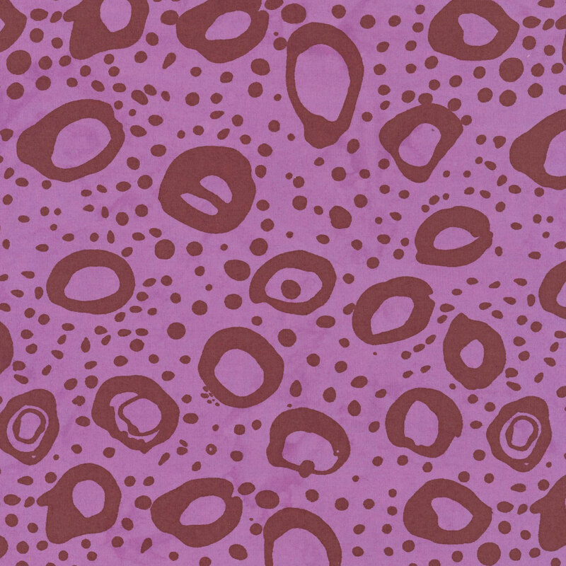 Orchid purple fabric with irregular stamped circles and dots in dark red.
