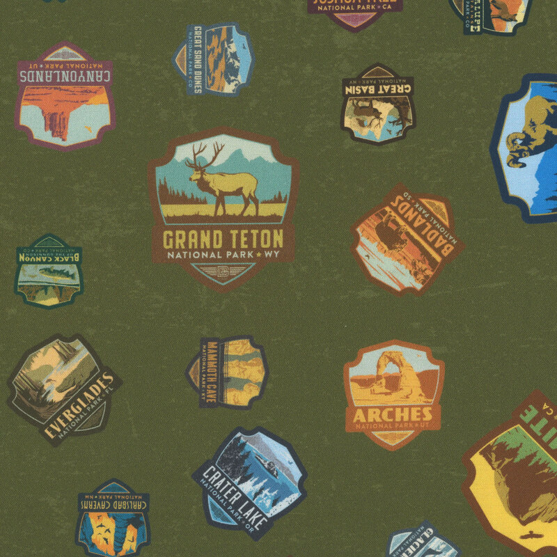 Green fabric with a playful tossed pattern of iconic national park patches.
