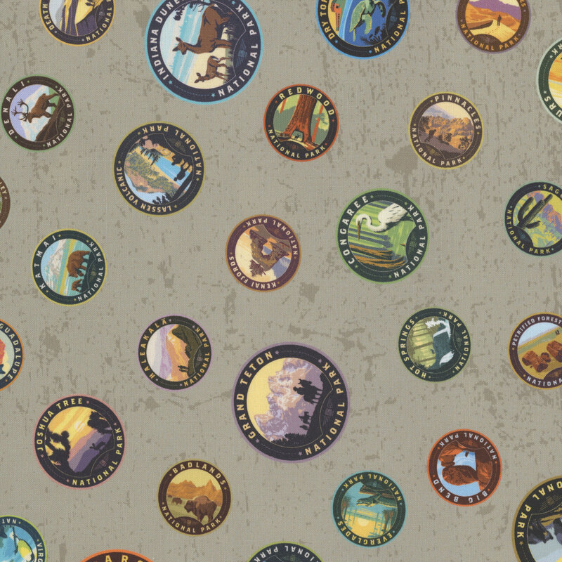 Gray fabric with a playful tossed pattern of national park patches.