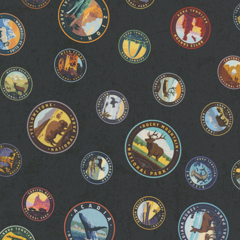 Navy blue fabric with a playful tossed pattern of national park patches.