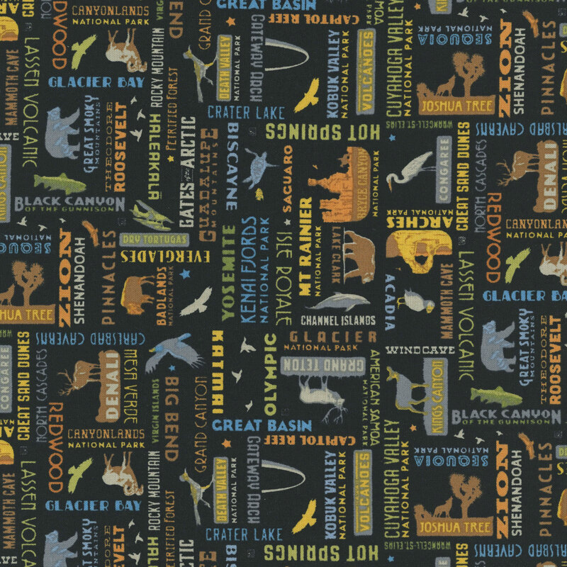 Black fabric with a playful tossed pattern of iconic national park logos.