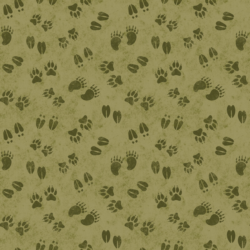 Green fabric with a playful tossed pattern of assorted animal tracks.