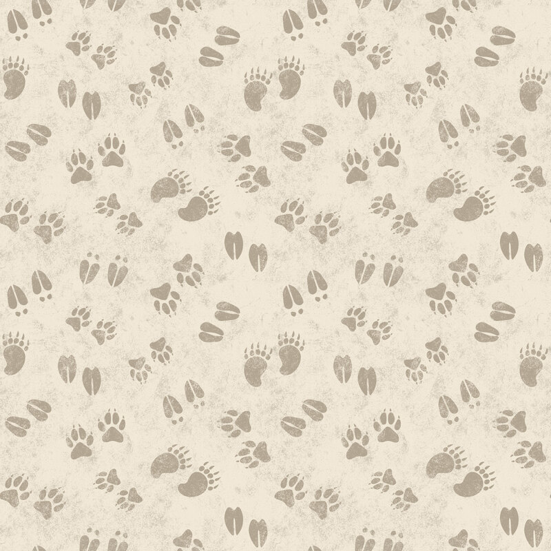 Cream fabric with a playful tossed pattern of assorted animal tracks.