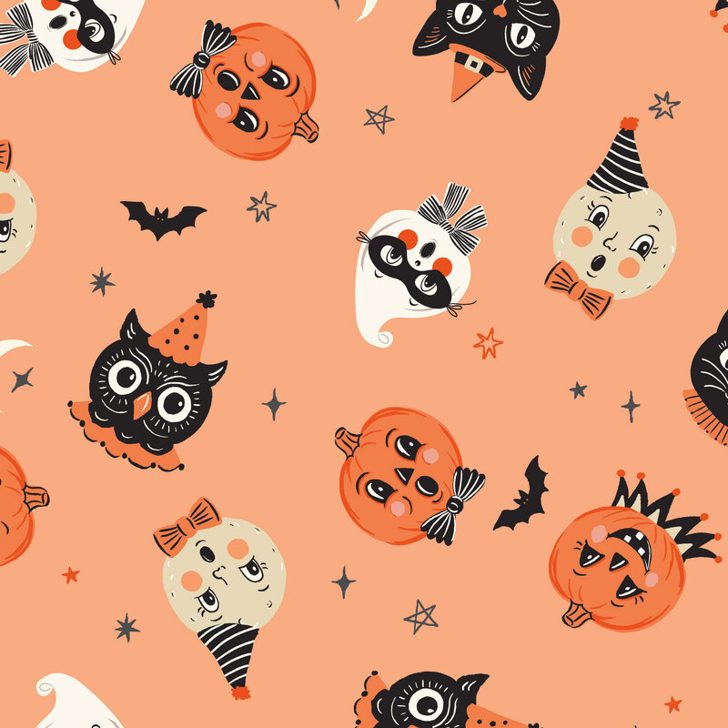 A persimmon fabric with tossed pumpkins, owls, moons, and ghosts.