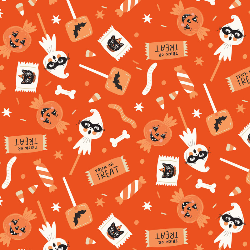 A bright orange fabric with scattered candies. 