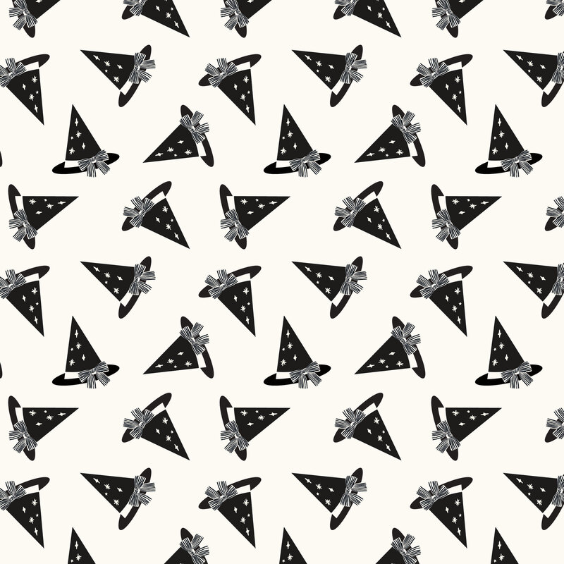 A white fabric with scattered black witches hats. 