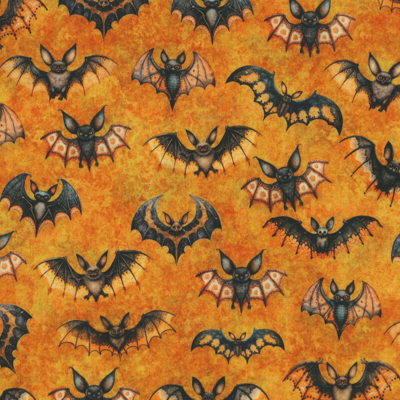 A swatch of orange fabric with various gothic styles of flying bats.