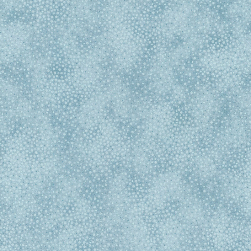 Mottled fabric with a medley of blue dots densely packed onto a pale blue background.