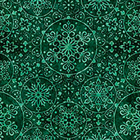A christmas green fabric with snowflake medallions.