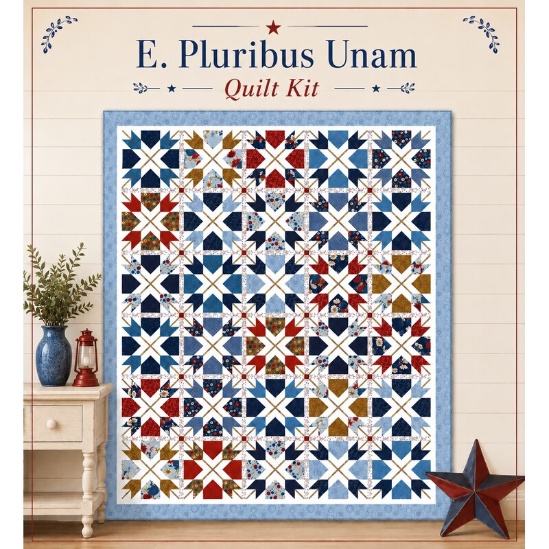 Mockup of the completed E. Pluribus Unum Quilt, a patchwork of dynamic shapes in patriotic colors on a cream background with text and props