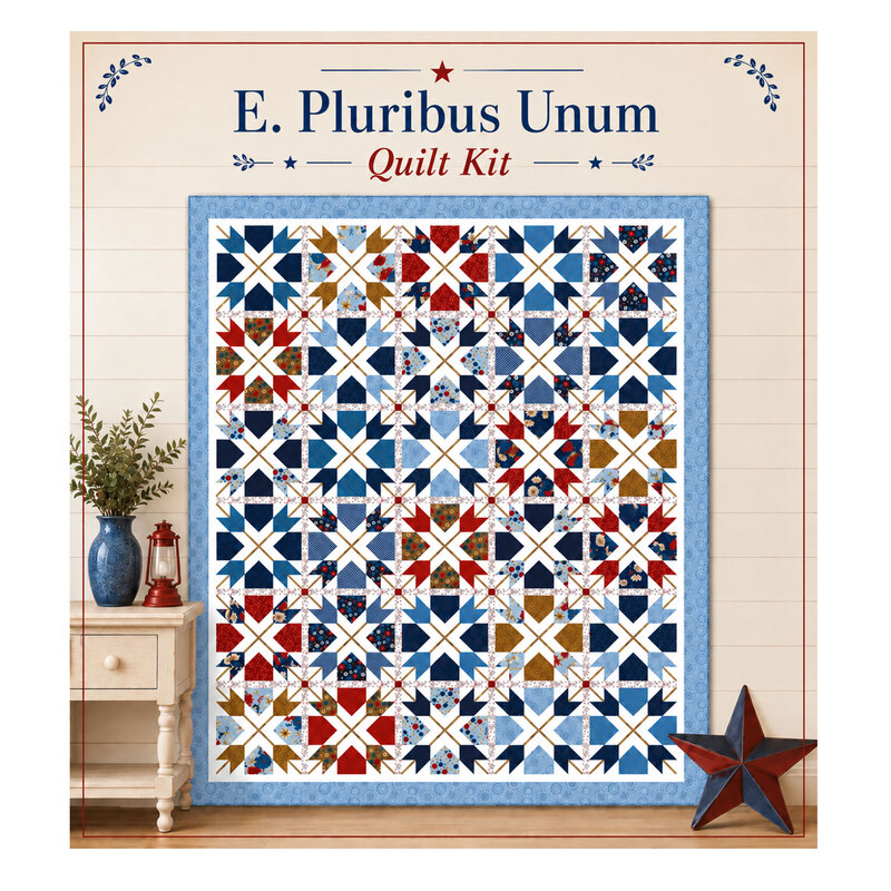 Mockup of the completed E. Pluribus Unum Quilt, a patchwork of dynamic shapes in patriotic colors, staged on a cream shiplap wall with coordinating décor.