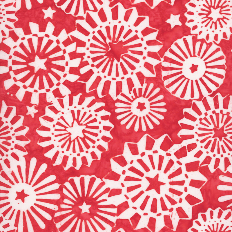 Cadmium red batik with a pattern of white blooming medallions accented with stylized stars.