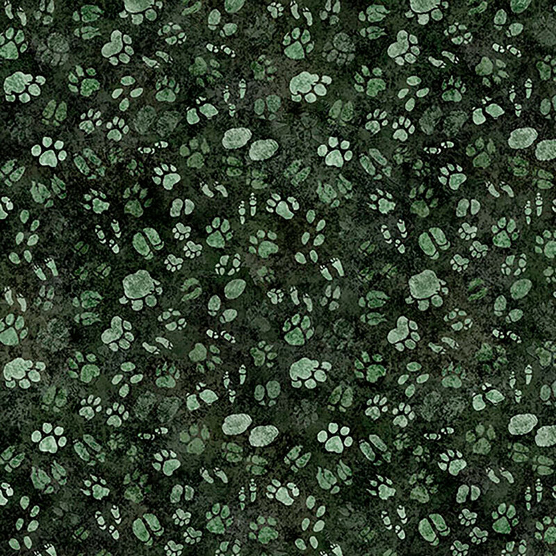 Mottled, deep pine green fabric with a tossed pattern of safari animal paw prints from sage to forest green.