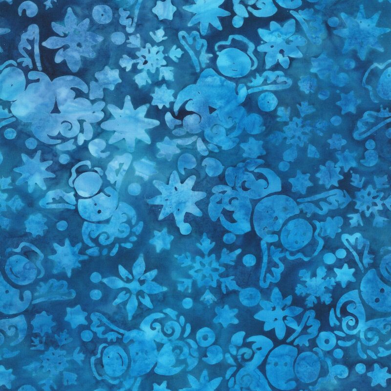 This mottled cobalt blue batik fabric features tonal motifs of snowmen, stars and snowflakes. 