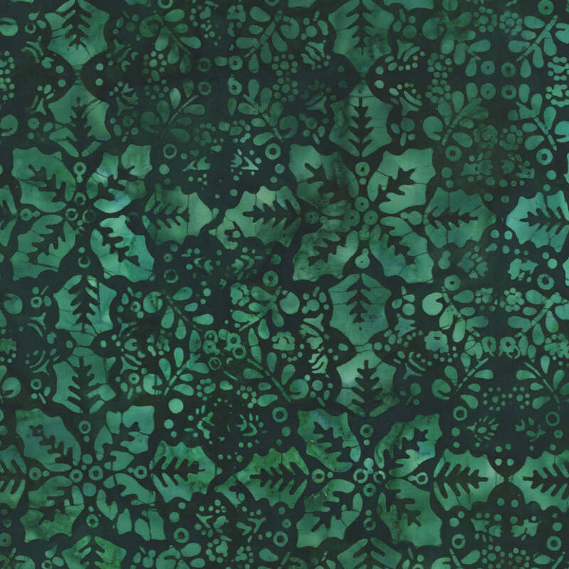 This dark green batik fabric features tonal holly leaves and springs in a repeating geometric design. 