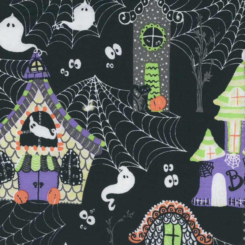 Black fabric with a mix of Halloween colors and motifs like large cobwebs, haunted manors, ghosts, black cats, and more.