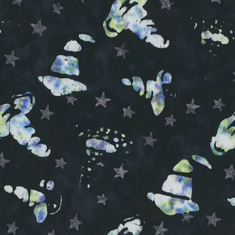 Black batik with a tossed design of gray stars and a medley of stylized purple, green, and white witch hats.