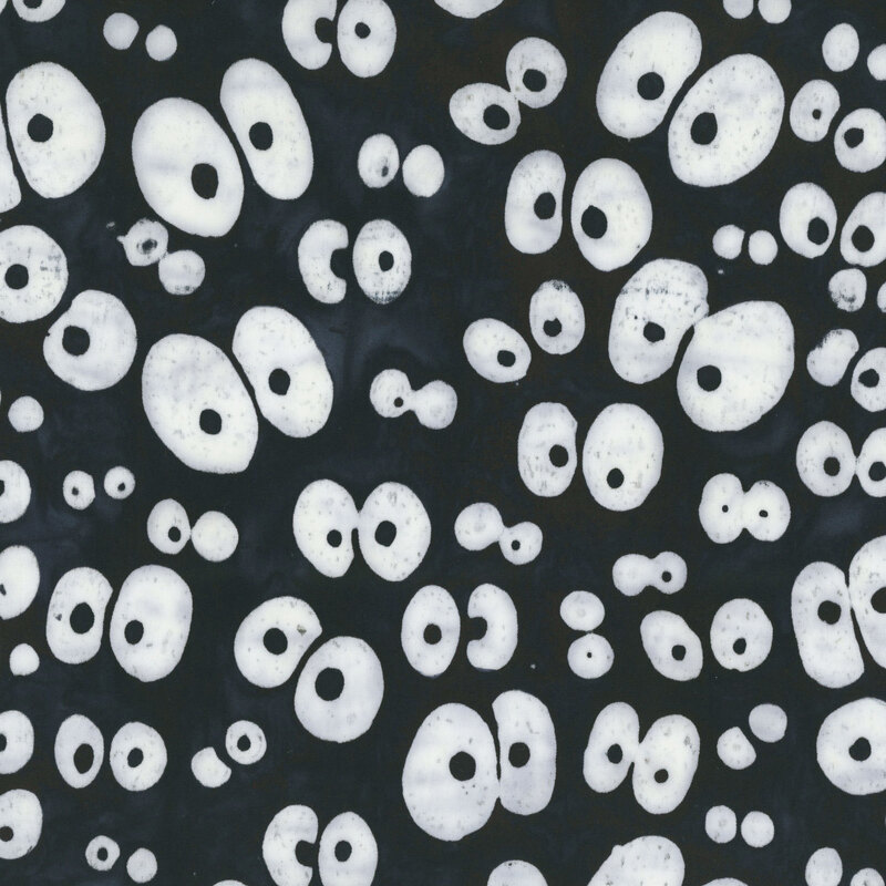 Black batik with a scattered pattern of large white googly eyes.