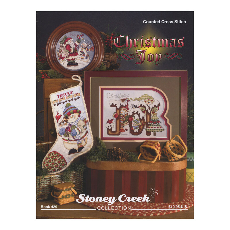 Front cover of the cross stitch pattern with the finished projects staged on a decorated background.