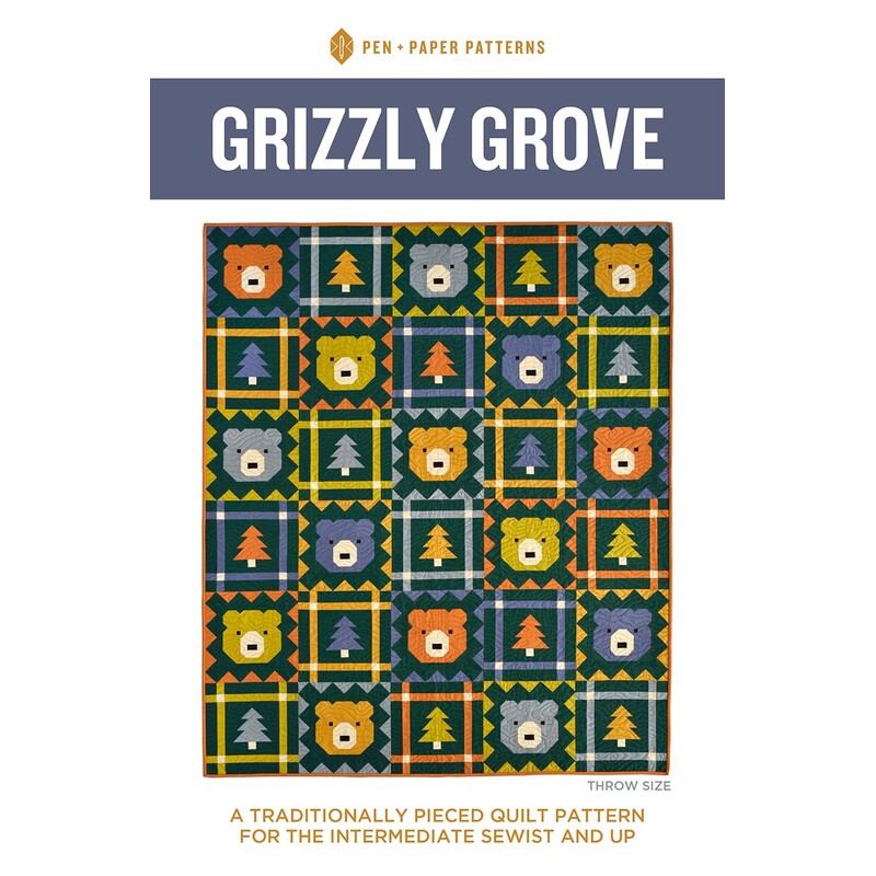 front cover of the Grizzly Grove featuring a navy quilt with alternating squares of bear heads and pine trees in shades of orange, gold, chartreuse, and blue,