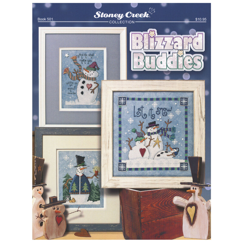 Front of the Blizzard Buddies cross stitch pattern showing the finished design framed with coordinated décor.