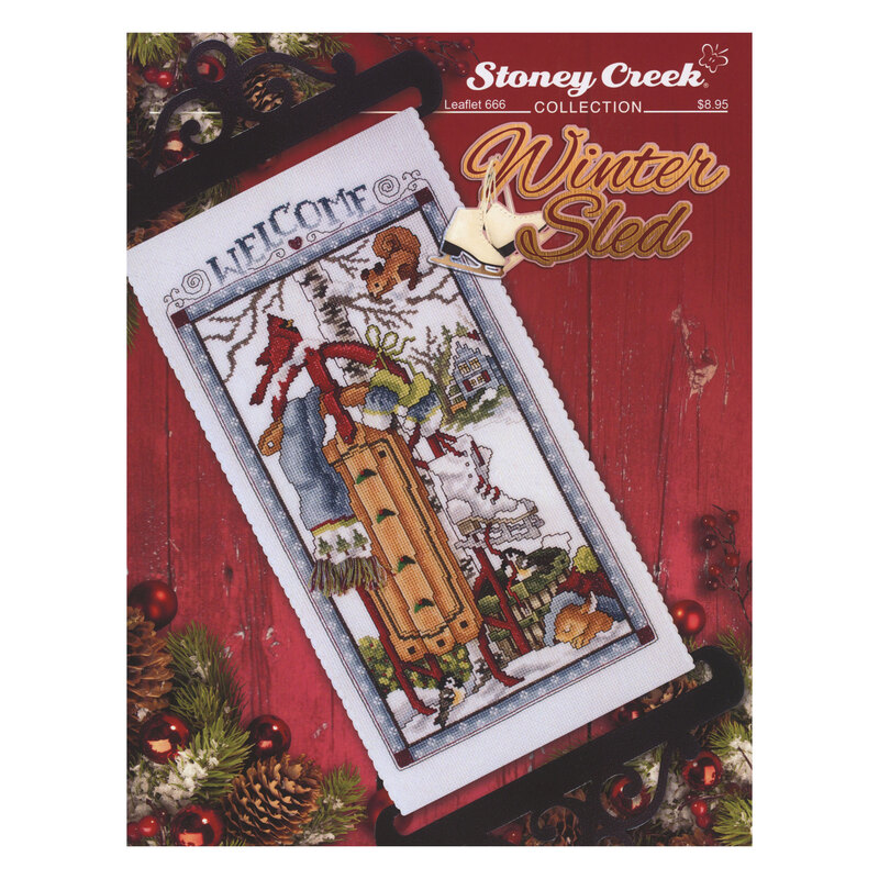 Front cover of the cross stitch pattern with the finished project staged on a red barnwood background.