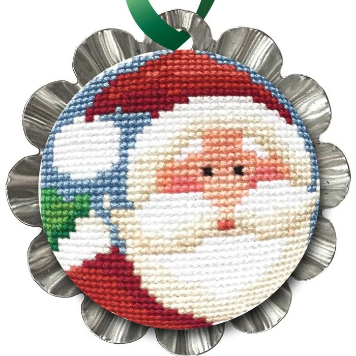 Jolly Santa Tin Kit featuring a cross stitched Santa Claus design framed in a silver tart tin with a green hanging ribbon.