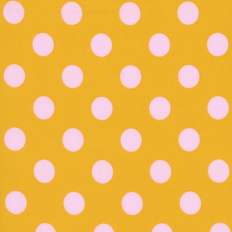 Ocher fabric adorned with a pattern of large, vibrant pink polka dots.