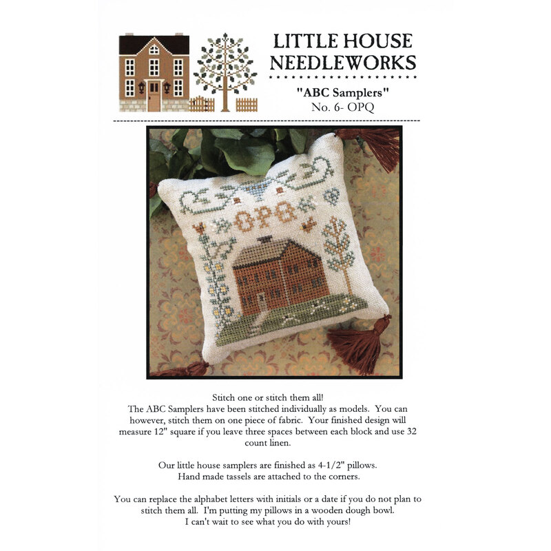 Front of pattern showing the completed cross stitch on a small ornament pillow staged on a floral fabric.