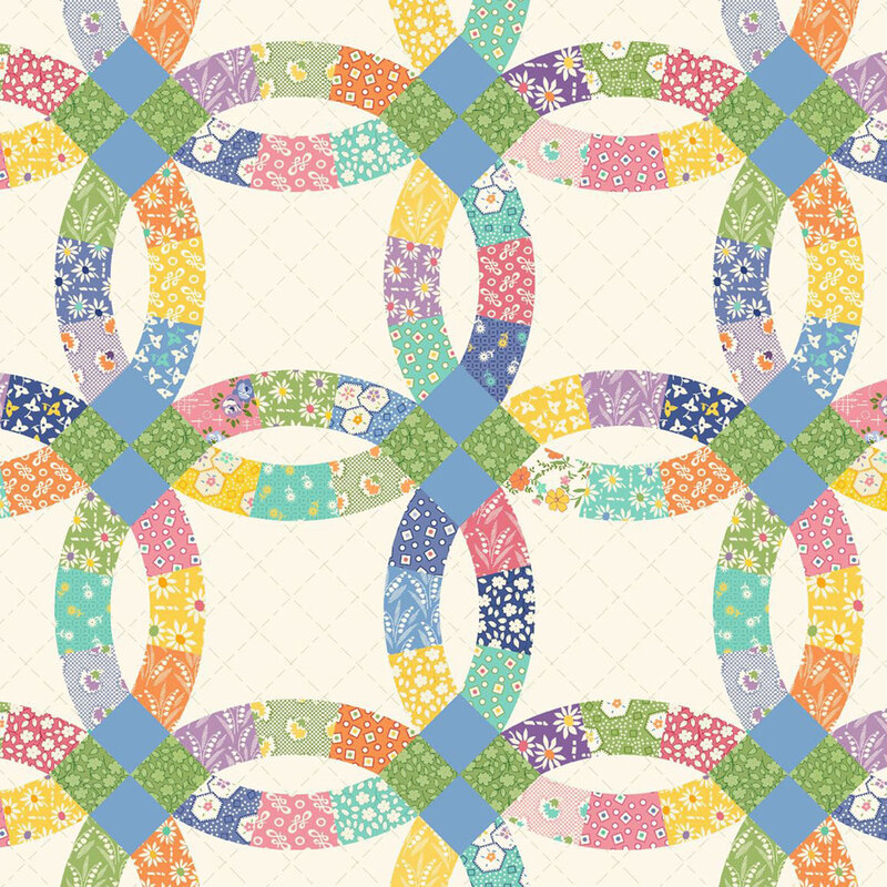Cream colored fabric with a biased grid texture topped with a cheater print in a wedding ring quilt block design.