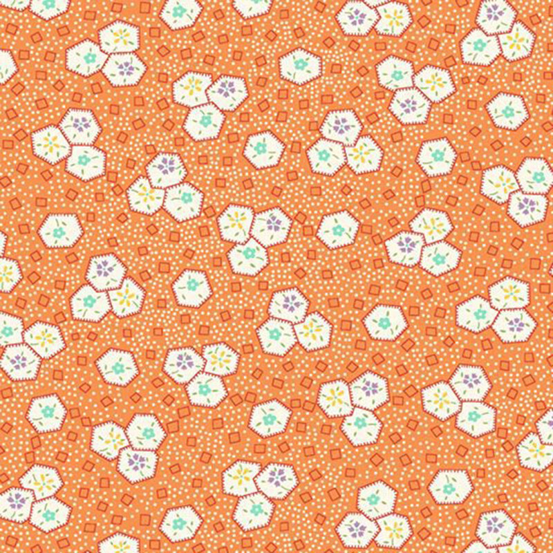 Tangerine orange fabric with a pattern of scattered white dots, orange geometrics, and floral-filled hexagons.