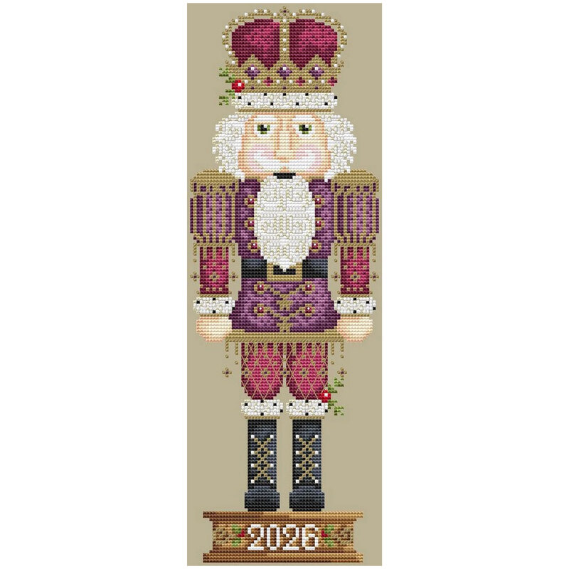 Finished cross stitch pattern of a nutcracker with a royal crown and purple clothing.