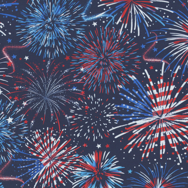 This navy blue fabric features bursts of red white and blue fireworks. 