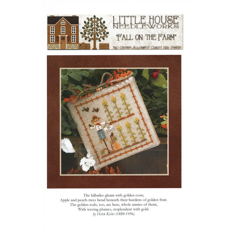 Front of pattern showing the completed cross stitch on a small ornament pillow staged on a table by autumnal sprigs.